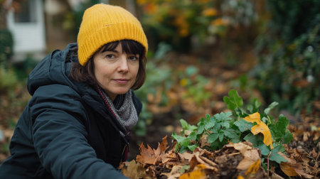 A woman diligently composts fallen leaves in her backyard, embracing sustainable gardening practices This simple act, transforming nature's bounty into nutrient-rich compost, nourishes her garden and contributes to a greener future It's a testament to the power of small actions in creating a more sustainable world AI Generativeの素材