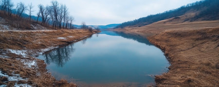 Embark on a breathtaking visual journey through a frosty winter wonderland Icy lake reflections dance with bare trees, creating a captivating landscape bathed in serene tranquility The cold morning air whispers of nature's sublime serenity, leaving you awestruck by its beauty AI Generativeの素材