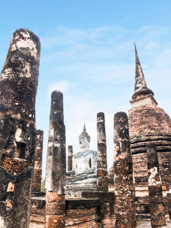 Ruin poles and pagoda around white Buddhaの写真素材