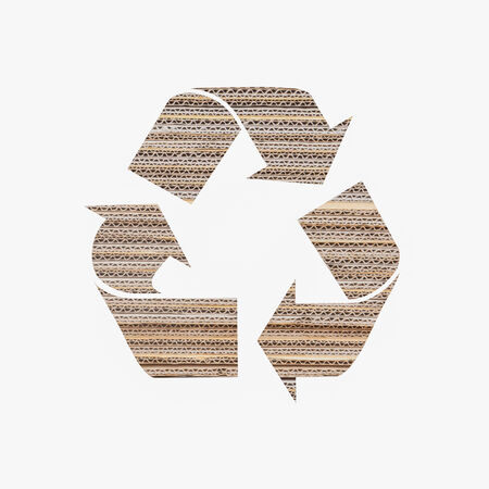 Recycle logo with corrugated paper isolated on white の写真素材