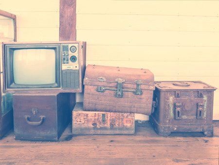  retro tv and boxes on wooden floor with vintage filter effectの写真素材