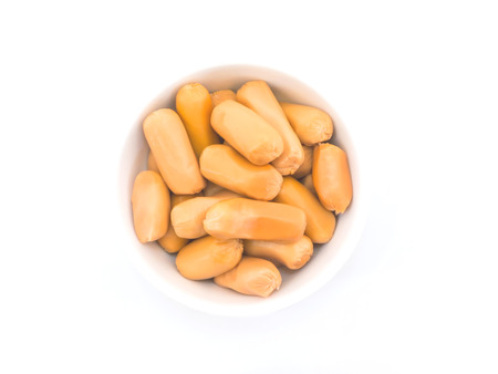 Cocktail sausages in white bowl on white backgroundの写真素材