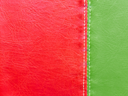 Green and red  leather with white stitch for Christmas background conceptの写真素材