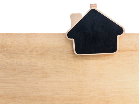 Pine wooden clipboard house shape with black paint center on wood boardの写真素材