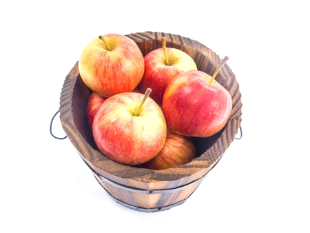 Over view of red apples in wooden bucket on white backgroundの写真素材