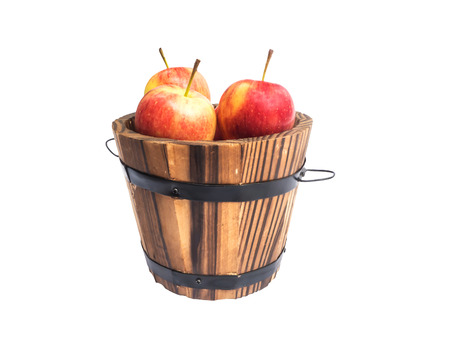red apples in wooden bucket isolated on white backgroundの写真素材