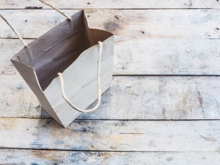 empty brown shopping bag on wood background