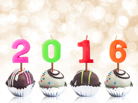 Chocolate ball in foil cup with candle 2016, Happy new year background