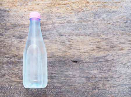 Cold plastic bottle water on the wooden tableの写真素材