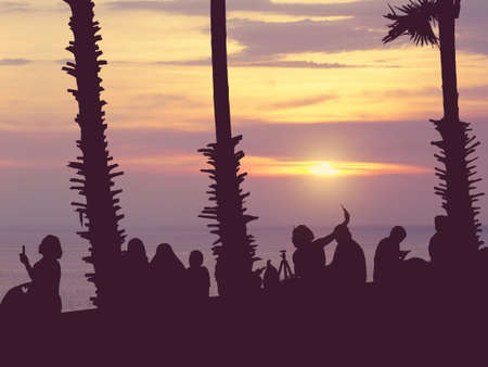 Silhouette people watching sunset and selfie at Phromthep Cape, Phuket, Thailand.Vintage filter effectの写真素材
