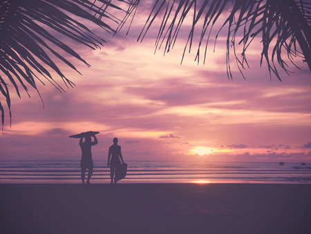 Silhouette Of surfer people carrying their surfboard on sunset beach, vintage filter effect with...