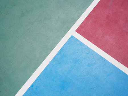 White line on colorful concrete floor of outdoor basketball court.の写真素材