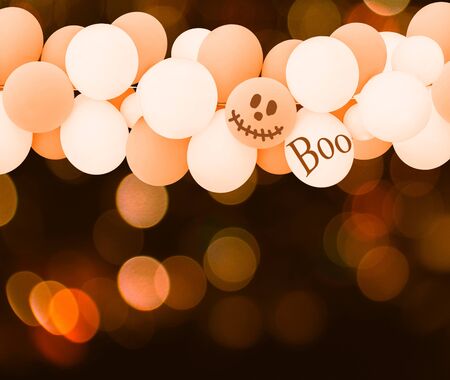Halloween background.Group of white and orange balloons over bokeh backgroundの写真素材