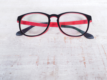 Black and red eye glasses on wood backgroundの写真素材