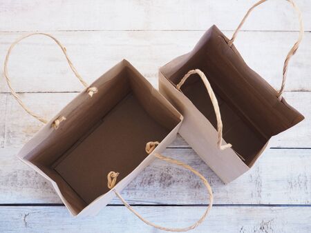 empty brown shopping bag on wood background