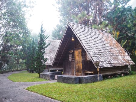 Old vintage wooden cottage in the forest with foggy morning.の写真素材