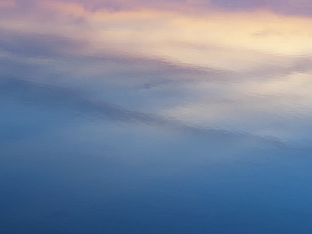 Abstract colorful background of sunrise sky reflection on water surface.の写真素材