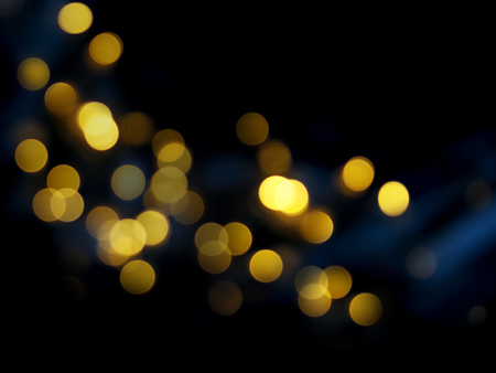 Dark abstract blured background with golden bokeh.
