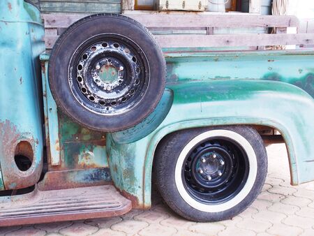 Spare tyre on vintage green truck in the garageの写真素材
