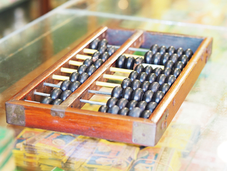 Vintage wooden abacus on glass counter at grocery storeの写真素材