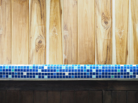 countertop mosaic tiles and wood cupboard in the kitchen or toiletの写真素材