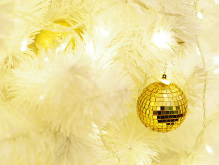 Winter holidays and christmas background concept. Close up golden glitter balls on fir pine tree...