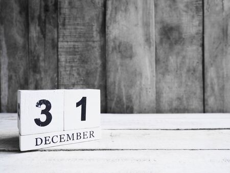 December 31st. White wooden block calendar show date 31 and month December on wood background with copy space. の写真素材