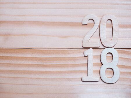 2018 New year wooden number on wood pine plank background with copy space. Vintage style.の写真素材