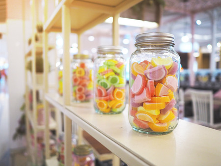 Bottle glass of colorful jelly candy display on shelf at grocery in department store.