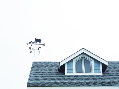 Sheep weathercock on the roof of barn isolated on white background.の写真素材