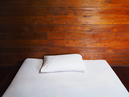 Close up white futon and pillow on the floor in vintage bedroom at country wooden house.の写真素材
