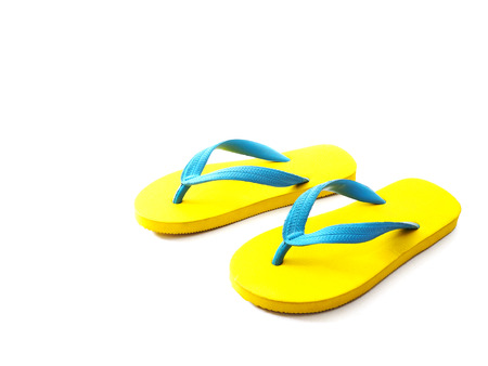 Top view of yellow and blue rubber flip flop shoes on white background. Summer holiday vacation concept.の写真素材