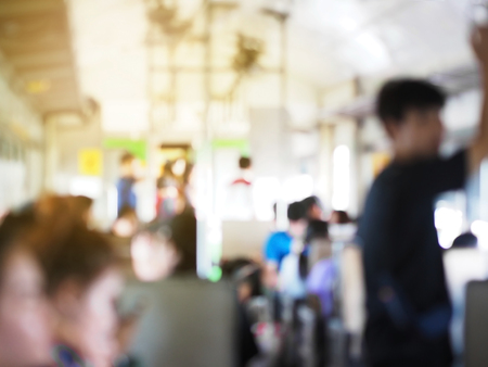 Abstract defocused blur background of people traveling in local economy class train at Thailand.