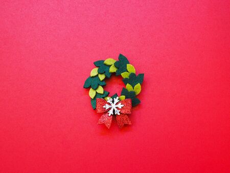 Close up Christmas handmade wreat ornament on red wallpaper background.の写真素材