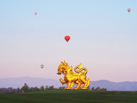 CHIANG RAI, THAILAND - February 12 2020 : Large golden Singha (Lion) statue over sunrise sky background with colorful balloons at Singha Park (Boon Rawd Farm), Chiang Rai province, Thailandのeditorial素材