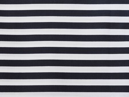 Close up surface white cotton fabric with black striped pattern background.の写真素材
