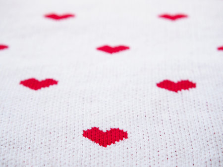 Red heart shape on white fabric texture. Valentine's day concept background.