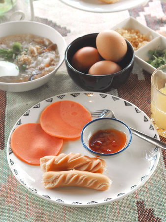 close up breakfast set in the morning with eggs and sauce on plateの写真素材