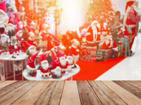 Wooden table top over  abstract blurred background of decoration for Christmas holiday or festive party at department store. Montage picture style to display the product. Shopping concept.の写真素材