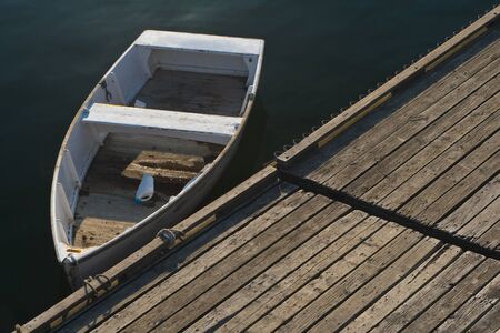 Details and abstract framing of small boats in New England harbor.
