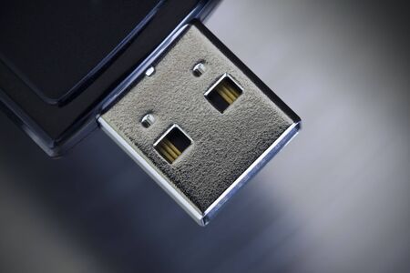Single USB thumb drive on a stainless steel background.の写真素材