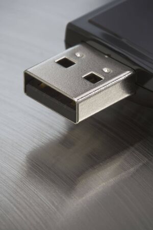 Single USB thumb drive on a stainless steel background.