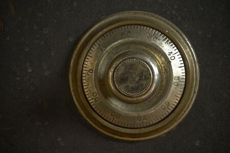 Close-up of a combination dial on an antique safe.の写真素材