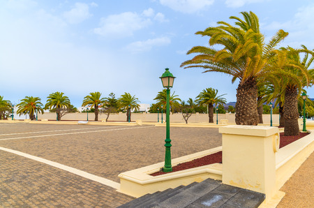 Palm trees on park square in Yaiza village, Lanzarote, Canary Islands, Spainの写真素材