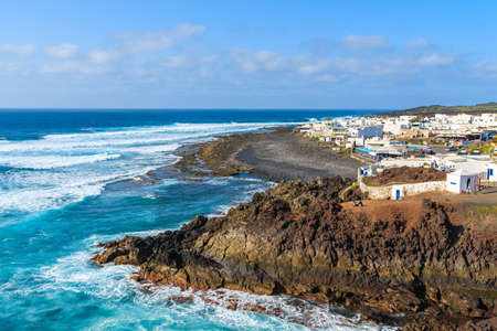 View of El Golfo village and blue ocean on coast of Lanzarote island, Spainの写真素材