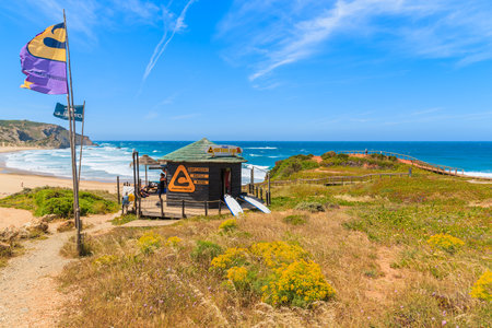 PRAIA DO AMADO BEACH, PORTUGAL - MAY 15, 2015: surfing school booth on beautiful beach in Algarve region. Surfing is popular sport in south western Portugal due to frequent strong winds here.のeditorial素材