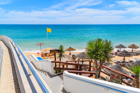 ARMACAO DE PERA BEACH, PORTUGAL - MAY 17, 2015: walkway to idyllic beach in Armacao de Pera seaside town, Algarve region, Portugalのeditorial素材