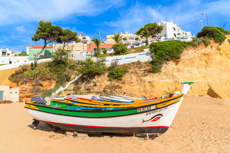 CARVOEIRO BEACH, PORTUGAL - MAY 17, 2015: typical fishing boats on beach in Carvoeiro coastal village. Carvoeiro is popular holiday tourist destination on Algarve coast.のeditorial素材