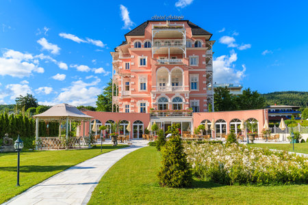 WORTHERSEE LAKE, AUSTRIA - JUN 20, 2015: luxury hotel Astoria and its gardens on shore of beautiful alpine lake Worthersee in suのeditorial素材