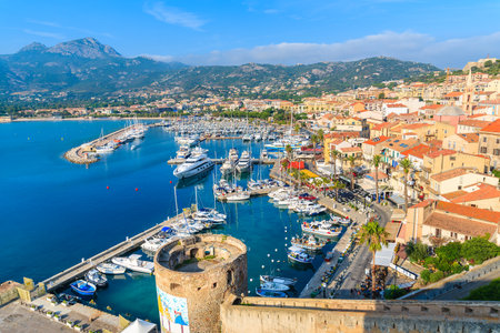 CALVI, CORSICA ISLAND - JUN 29, 2015: view of boats and colorful houses in Calvi port. This town has luxurious marina and is verのeditorial素材
